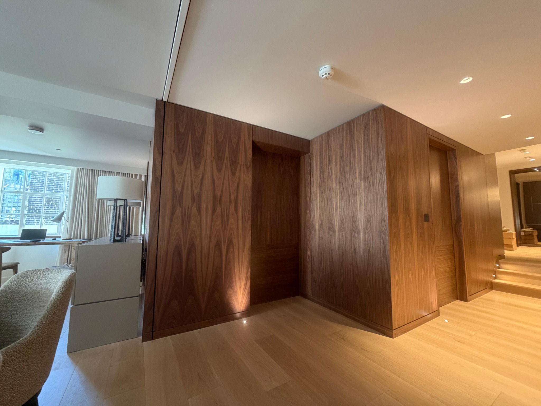 Timber wall panelling and concealed doors alongside a staircase