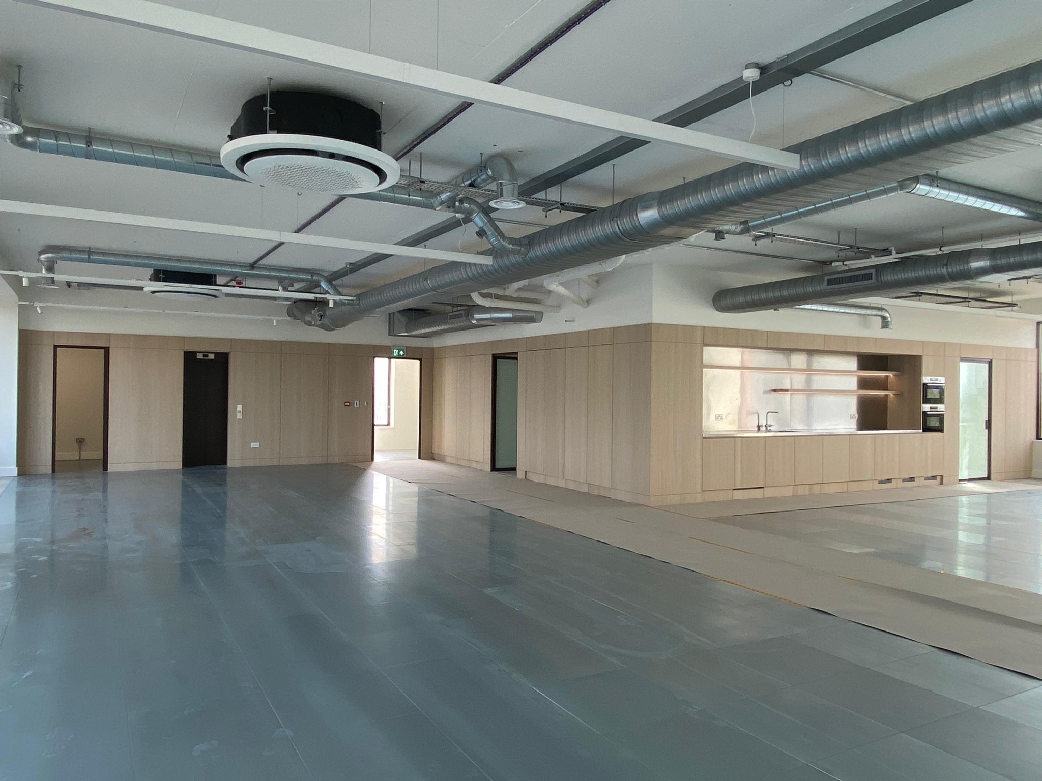 Commercial space with fitted timber panelling, doors and kitchenette